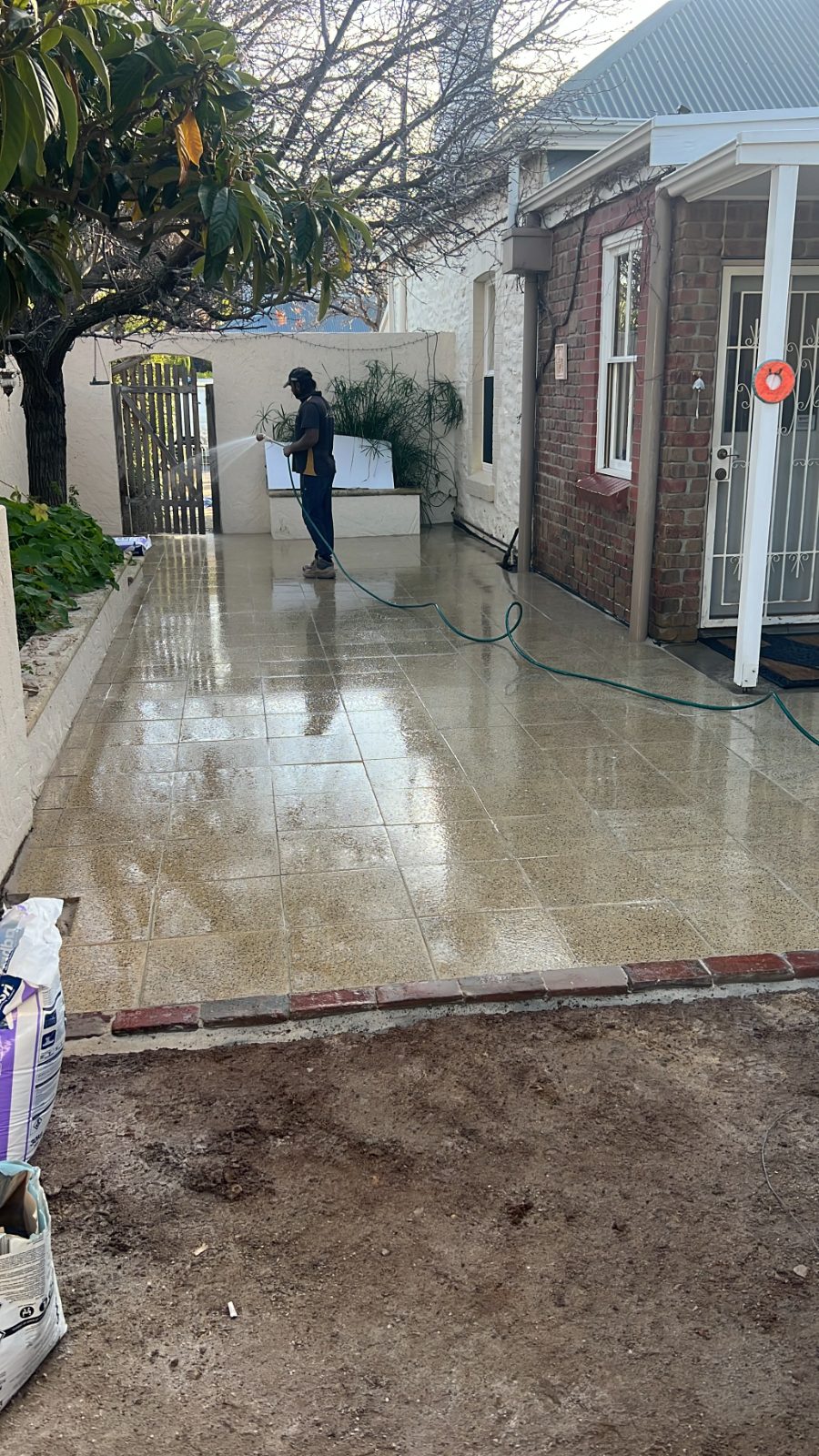 Pressure washing a paved path — real AOI job